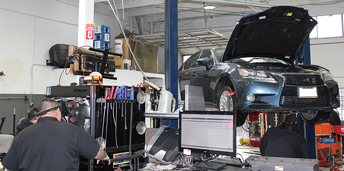 Car raised up on lift in garage | Silicon Valley Performance Truck & Auto Repair